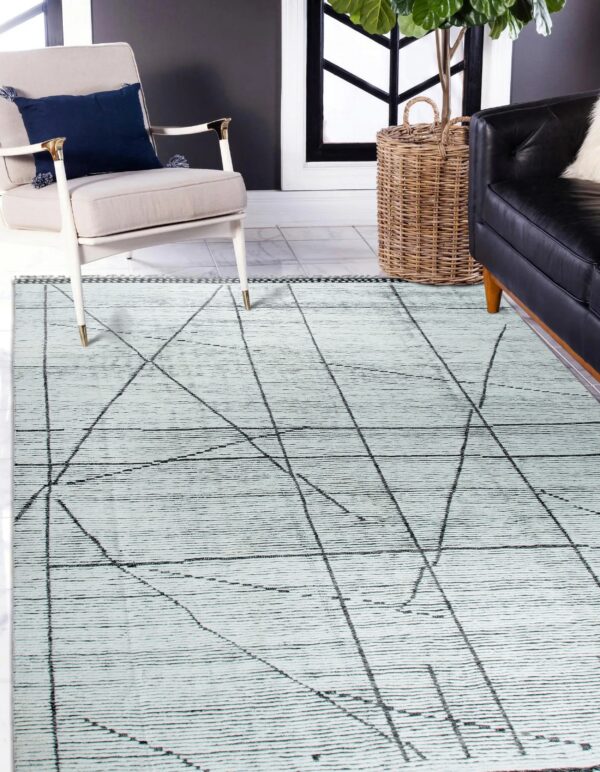 Textured light blue rug featuring abstract intersecting black lines displayed under modern furniture on tile.