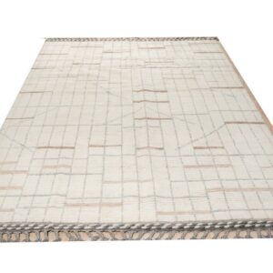 Cream shaggy rug displaying a light geometric grid pattern with tan horizontal accent stripes and dark gray fringe.