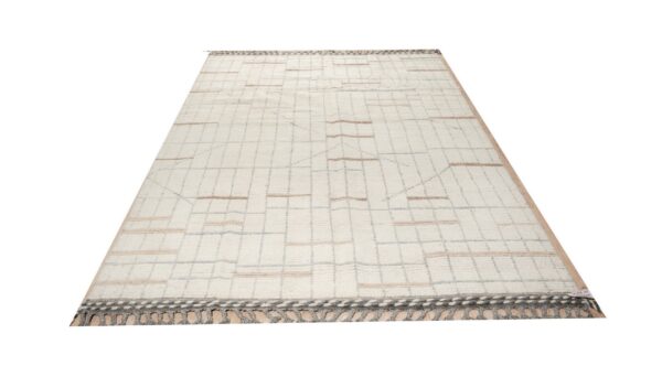 Cream shaggy rug displaying a light geometric grid pattern with tan horizontal accent stripes and dark gray fringe.
