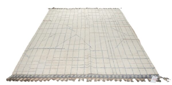 Textured cream rug with pale blue-gray geometric lines and gray decorative tassels at one end.