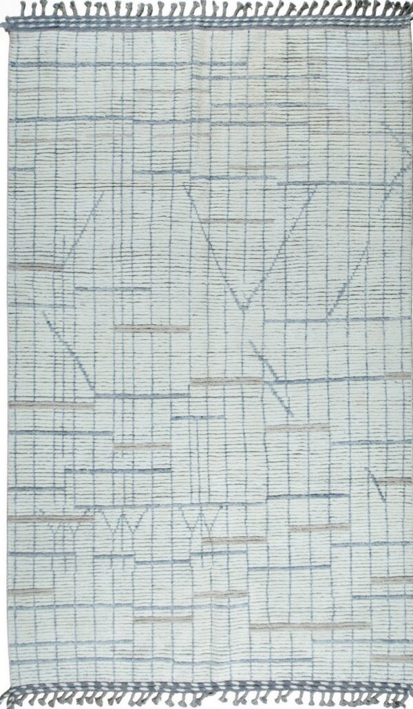 Off-white textured rug with a subtle gray grid pattern and layered blue and beige abstract geometric designs.