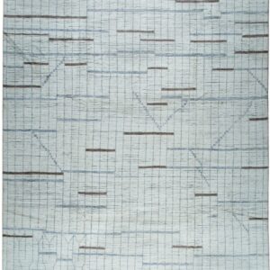 Textured off-white rug featuring a blue grid pattern, brown dashes, subtle geometric lines, and decorative gray fringe.