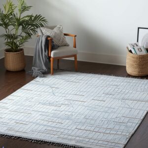 A light gray flat-weave rug with a blue grid pattern and tan accents rests on dark wood flooring.