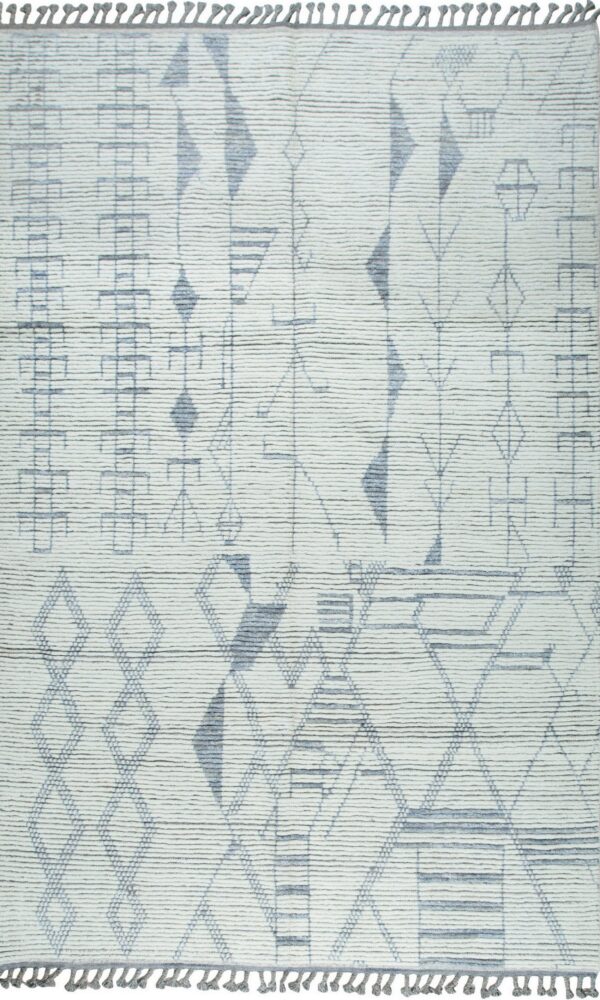 Textured off-white rug with an asymmetrical geometric design in dusty gray-blue and visible fringe.