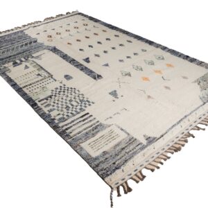 High-pile cream rug featuring an asymmetrical abstract pattern in shades of blue, gray, and orange, with tassels.