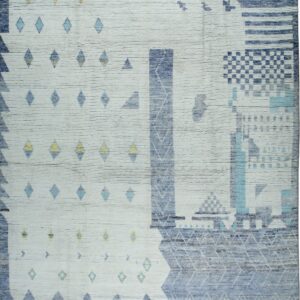 Ribbed white rug featuring an abstract geometric pattern in shades of blue, aqua, and yellow with fringed edges.