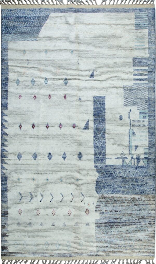 High-pile off-white rug featuring abstract blocks of blue and scattered small geometric motifs in magenta and teal.