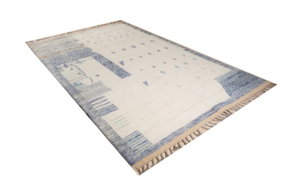High-pile cream rug with abstract borders and geometric shapes in blue, light blue, and pink.