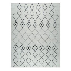 High-pile off-white rug with bold black outlined diamonds and small solid geometric geometric shapes.