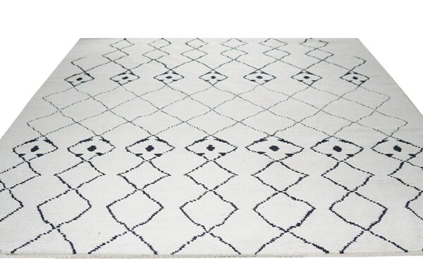 Textured white rug featuring a repeating large diamond lattice pattern in dark geometric lines.