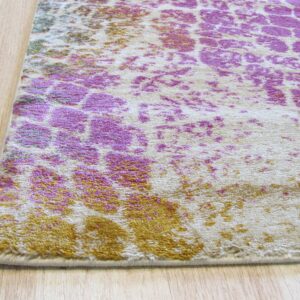 Cream rug with a short pile and distressed magenta and mustard pattern lying on light wood flooring.