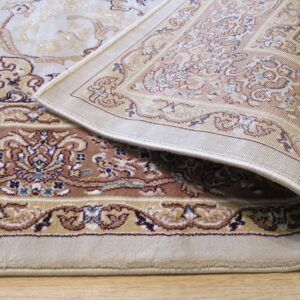 Beige and brown traditional rug with floral motifs folded on light wood flooring, showing the woven backing.