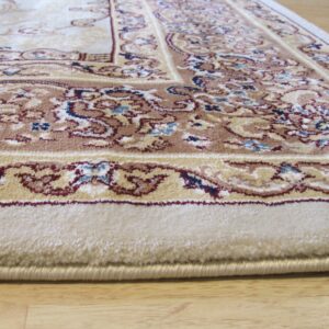 Medium-pile cream rug with a traditional brown and red border rests on light wood flooring.
