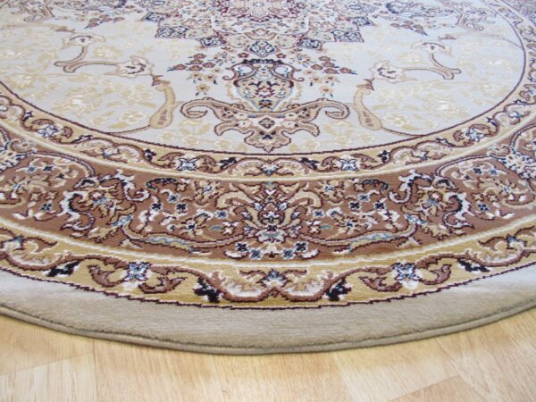Circular rug with a traditional cream and brown medallion pattern sits on light blonde hardwood flooring.