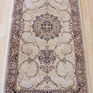 A beige runner rug with a traditional brown medallion pattern rests on light wood flooring.