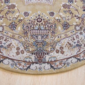 Rounded edge of a beige traditional rug featuring an elaborate floral vase pattern on light wood flooring.
