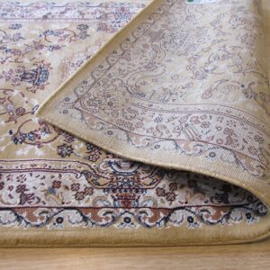 Beige traditional rug with floral motifs in red and blue, curled back to show the tightly woven underside on wood.
