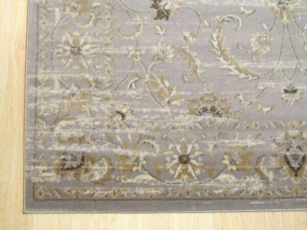 The light gray rug features a traditional distressed pattern in cream and gold on blonde wood.