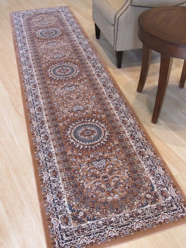 Brown traditional runner rug on light flooring next to a nailhead-trimmed chair and round wood table.