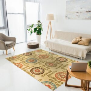 Yellow rug with large red, blue, and brown medallions in a bright room with a sofa and armchair.