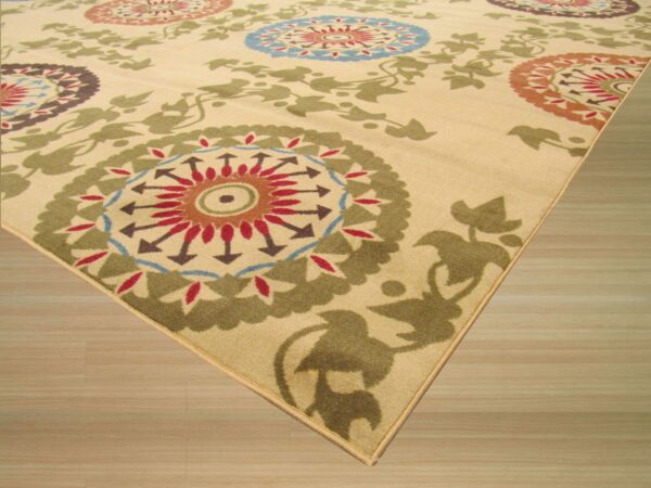 Beige rug featuring vibrant medallions and olive green vine patterns shown on light wood flooring.