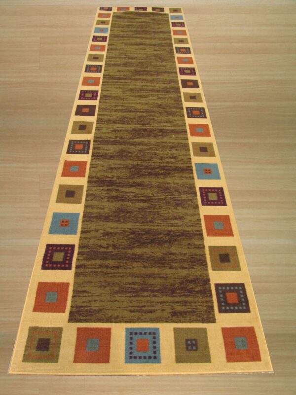 A long runner rug on light wood flooring features a mottled green center framed by a tan border with multicolored squares.