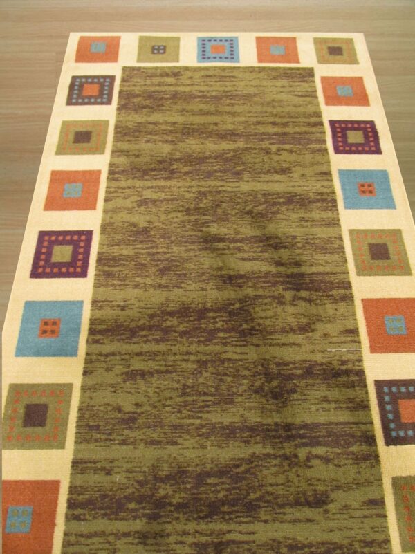Green and brown striated rug with a cream border containing large multicolored geometric squares on wood flooring.