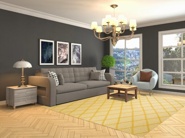 Bright yellow rug with white concentric diamond patterns anchors a gray sofa on light wood flooring.