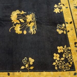 Navy and gold rug showing elaborate floral patterns and a detailed mythical figure on a soft pile.