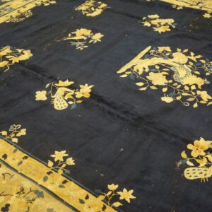 High-pile navy rug detailed with golden flowers and stylized peacocks, framed by a broad yellow border.