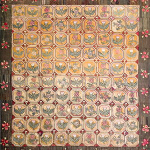 Square rug with a golden octagonal field pattern featuring thistles and roses, framed by a dark floral border.