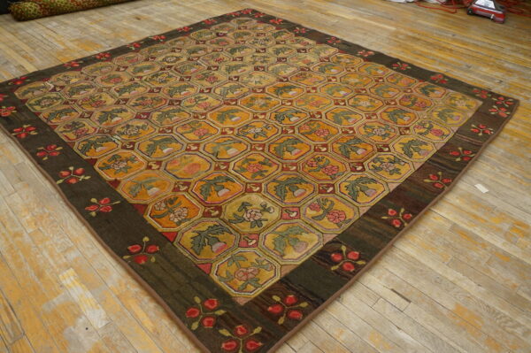 Textured rug with yellow, red, and green hexagonal floral motifs on a distressed plank wood floor.