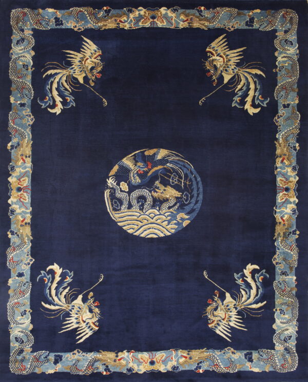 Deep blue rug with corner phoenixes, a central medallion, and a wide border of stylized blue dragons.