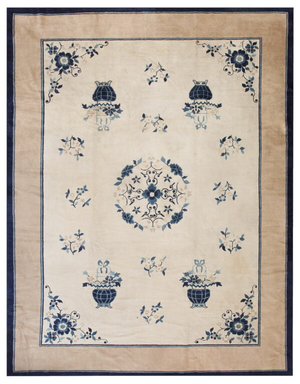 Cream and blue floral rug with a central medallion, stylized urns, and a wide solid tan border.