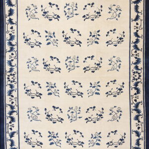 Rug with a beige field, repeating blue floral motifs, and a wide blue botanical border.