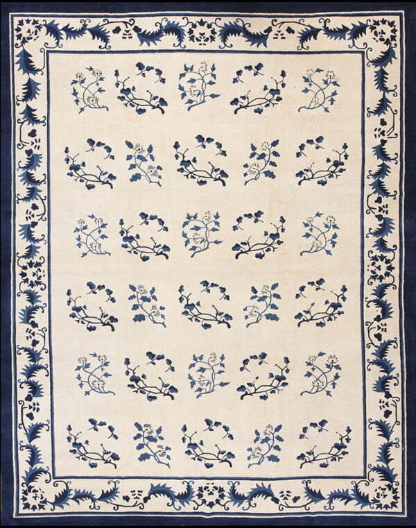 Rug with a beige field, repeating blue floral motifs, and a wide blue botanical border.