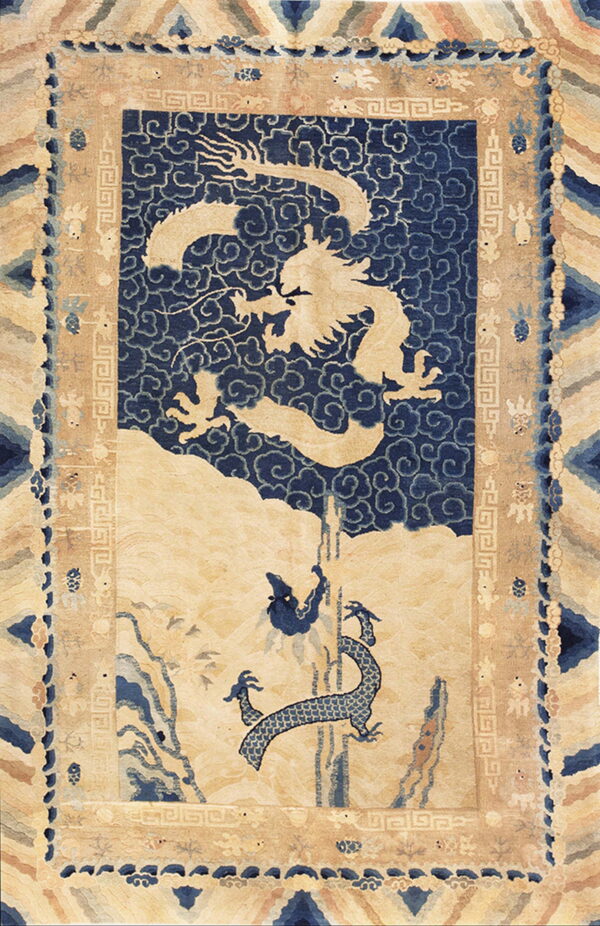 Traditional blue and beige rug featuring a detailed celestial dragon over a scenic mountain landscape.