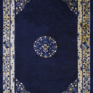 Dark blue rug featuring a central medallion and ornate gold and blue floral borders.