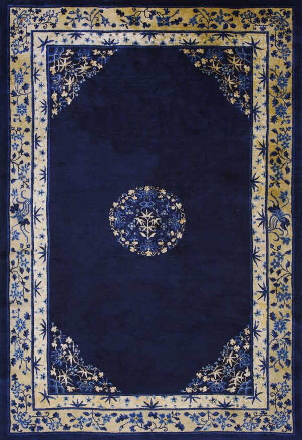 Dark blue rug featuring a central medallion and ornate gold and blue floral borders.