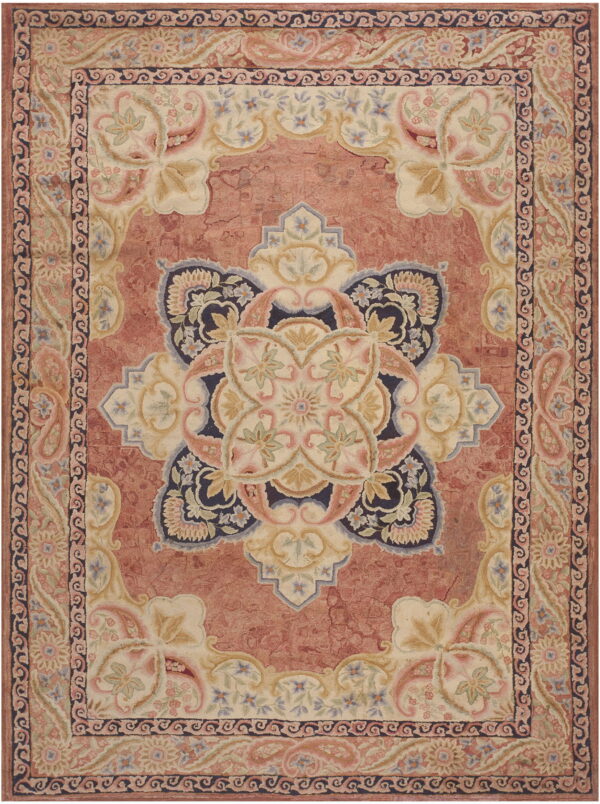Terracotta and cream traditional medallion rug featuring navy blue and pastel floral carvings.