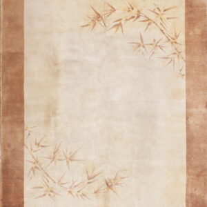 Beige rug featuring a solid brown border and faded bamboo leaf motifs in opposing corners.