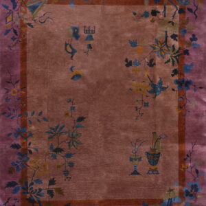 Ornate rosy brown rug with a wide mauve border and detailed blue and yellow floral vine and object designs.