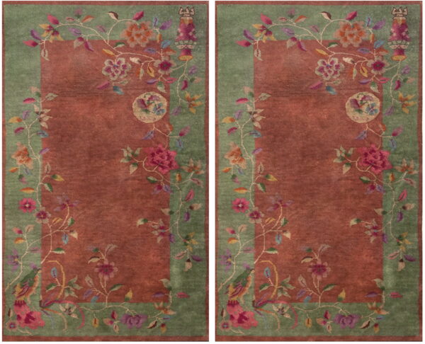 Two rugs with rust-red fields and green borders decorated with flowing multicolored floral patterns.