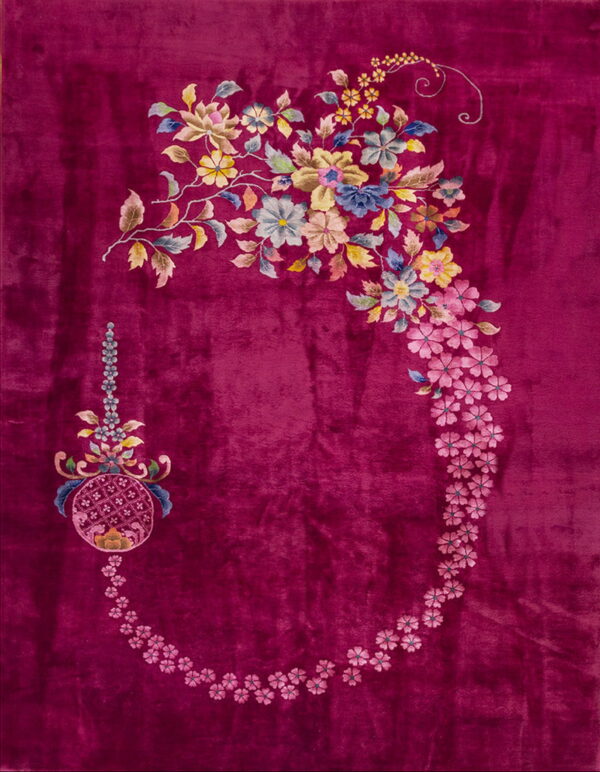 Deep magenta rug with high pile features an asymmetrical floral garland and medallion in multicolor tones.