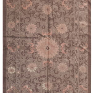 Traditional rug in shades of taupe and brown with pink floral medallions and geometric borders.