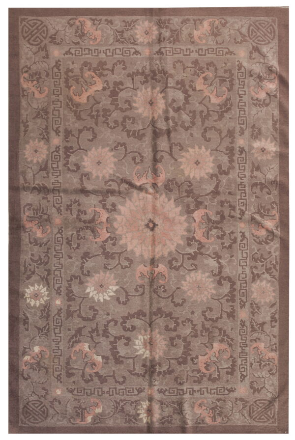 Traditional rug in shades of taupe and brown with pink floral medallions and geometric borders.