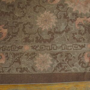 Low-pile rug with brown, taupe, and peach floral and stylized patterns lies on a light wooden floor.