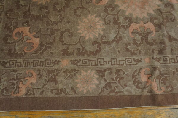Low-pile rug with brown, taupe, and peach floral and stylized patterns lies on a light wooden floor.