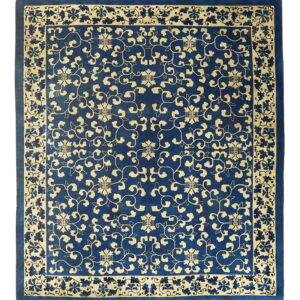 Deep blue square rug with pale yellow stylized vines and flowers repeating across the field and border.
