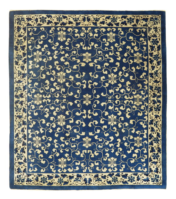 Deep blue square rug with pale yellow stylized vines and flowers repeating across the field and border.